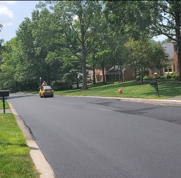Asphalt compaction is done by two people, each on a different size vibratory rollers